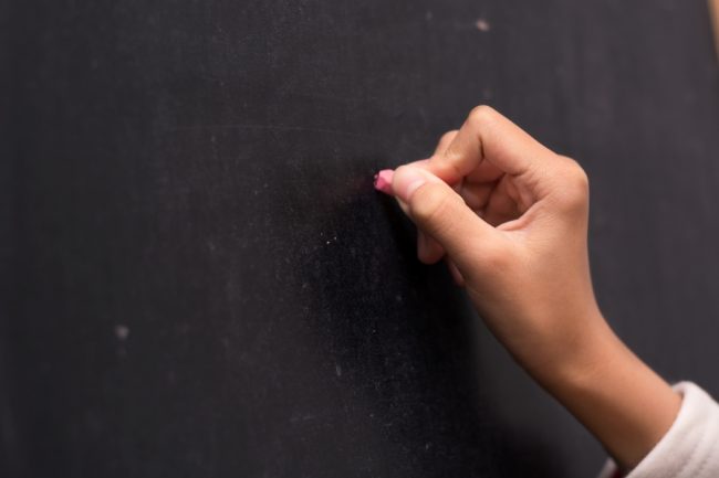hand with chalk, starting to write